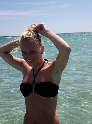 "Here's a pic of some chick with her tits out, walking up to the shoreline while she tries to keep her coochie dry."