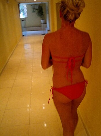 """
Check out this fucking hot chick, drowning in that red bikini as she struts her shit through some stupid indoor corridor. Goddamn. 30 words. English only."""