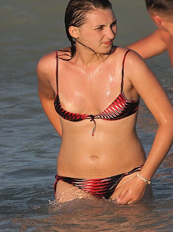 Here's a fucking picture of some hot bitch standing in the goddamn ocean, wearing only her bikini. Fucking awesome!