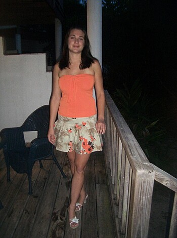 Vulgar description: "Here's a fucking picture of some hot chick in a short skirt and tight tank top, showing off her tits and ass on the goddamn porch."