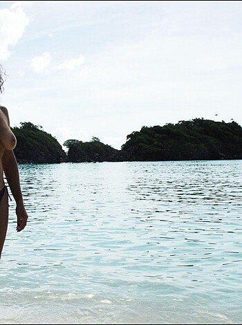 "Here's a pic of some chick, strippin' down on the beach, flauntin' her tits and crack while holdin' up some booze."