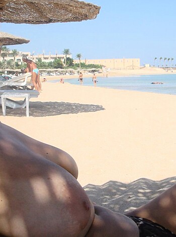 Here's your hot piece of ass sunbathing on the beach with her tits out, get a load of that chest meat.