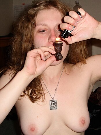 The blonde bimbo is smoking a fucking ciggie while completely stark naked.