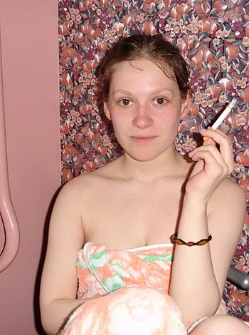 """
A naked chick smoking in a tub with her boobs out for all the world to see.
"""