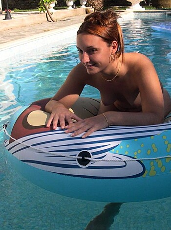 "Here's a nude chick with tits out, floating on some dick-shaped rubber thing."