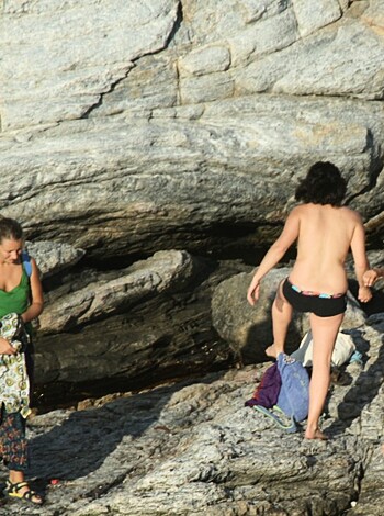 "Here's a photo of two hot bitches tanning their bikini-clad bods on the beach while one cunty chick with a boner sneaks up behind them to creepily watch 'em, no doubt."