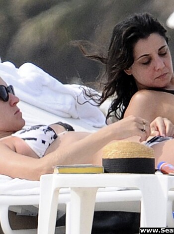"Two bare-titted bitches lying in beach chairs."