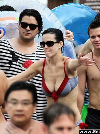 Bitches exposing their ta-tas on the beach.