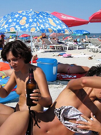 "
Fuckin' hot chicks on a fuckin' beach with their bare asses and titties out, soaking up some sun in all their nude glory."