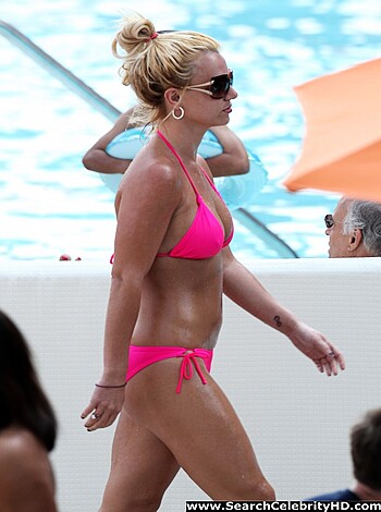 "Check out this hot chick in a bikini strutting around a pool deck while flashing her flat stomach. She's got shades on and some cute earrings."