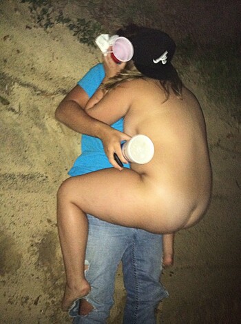 Here's a fucking picture of two dicks cuddling on a sandy clitoris, at nighttime.