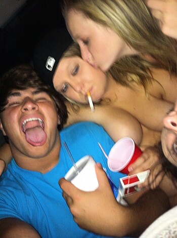 Group of friends fucking off at a party, bitches making out while smoking cigarettes and shit.