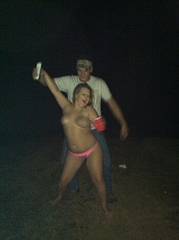 A chick in a pink bikini is jiggling her tits while swinging around a drink cup, and some dude in the back is guzzling down a fuckin' brewski from a motherfuckin' can.