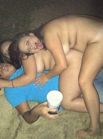 This picture depicts two horny babes rubbing one dude's hard dick in their eager hands, all while he stands there completely nude.