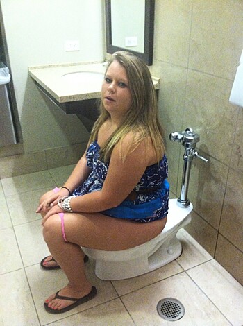 "Here's a picture of some hot chick taking a shit while wearing a barely there bikini. She's got her tits hanging out and her ass is hanging off the seat, probably from all the shitting she's been doing lately. You can see her bush poking through those little strings, too. If you ask me, this looks like one fucking classy way to take a shit."