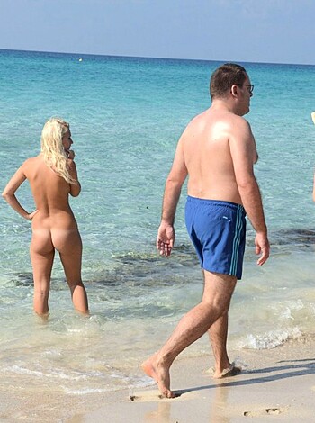 Here's some f***in' dudes walking on the beach with their dicks out and shit. The guy in front has a blue speedo on but it's barely covering his meat, while behind him is another dude with a smaller package, maybe cuz he doesn't workout as much or some shit like that. Anyway, they all look pretty damn happy to be showin' their asses to the world like this.