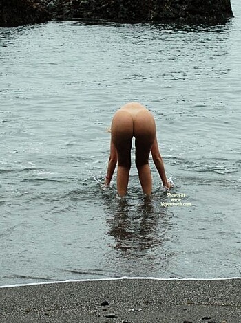 The guy is cleaning up his junk after pissing on the rocks.