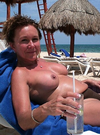 "Here's the photo of a bare-titted broad chillin' on the sandy shore with a bracer and sippin' through a straw."