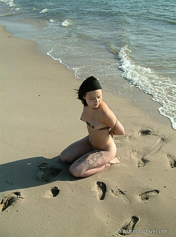 "Busty bitch with tits out on the sand, rocking some bikini ass."
