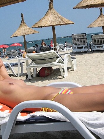 """
Check out this hot chick sunbathing tits-out at the beach! What a fucking babe. Fuckin' A. 
 """