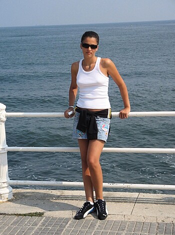 Bitch is loungin' on the fucking deck by the dick-sucking sea while she got her titties in some goddamn bikini tops and shit.