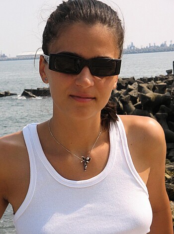 "Here's your typical bikini-clad, tits-out chick, slayin' the fucking shit outta this goddamn rocky shore while her tits jiggle and her nipples poke through that fuckin' tank top like some kinda perverted porno. I mean, come on - look at those titties! They practically explode out of that shirt like a motherfuckin' volcano. And them abs? Jesus Christ, those abs are so damn defined you can see every fucking ripple in 'em. Goddamn."