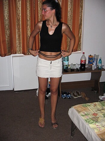 "Check out this bitch with the hot bod, standing in front of a fucking bed, showing off her toned abs and sexy legs."