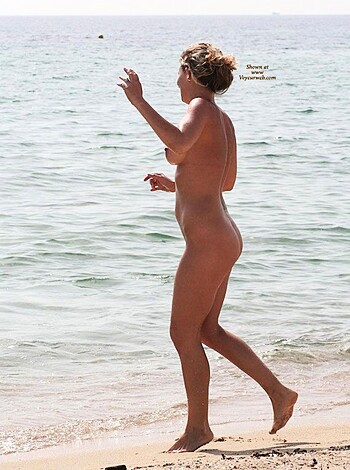 Here it is folks, your chance to see a fucking hot bitch walking down the beach with her tits and pussy hanging out for all to see. Fucking sexy as hell, I'd give anything to be that guy watching from behind my camera lens. This picture is the shit.