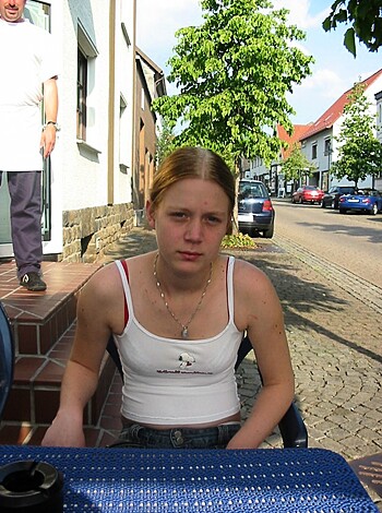 Fucking hot chick with tits hanging out while sitting at the table, bitch.