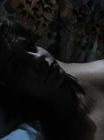 Here's a shot of some naked chick laying on her side with her head tilted to the fucking side.
