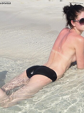 A nude bitch tanning her fat ass with no tan lines at the shore.