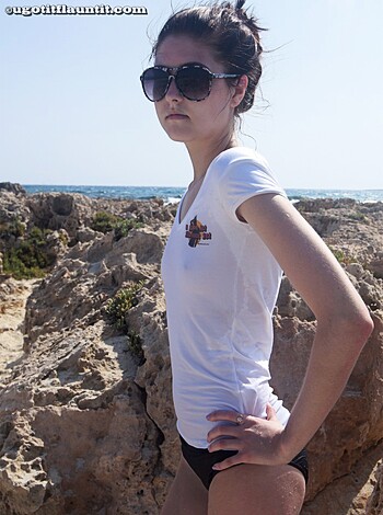 Vulgar description:
"This photo is a fuckin' hot chick in a tight-ass bikini top and ass-hugging shorts pose by the ocean with some goddamn fancy shades and killer red bottom heels. Fuckin' aye."