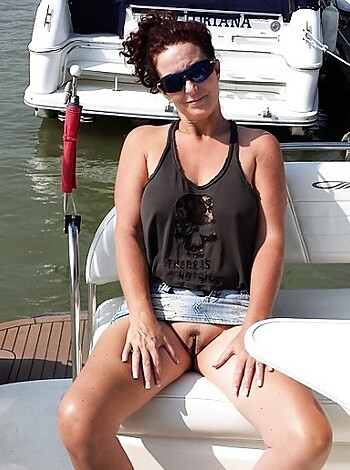"Here's an image of a hot bitch on a boat wearing only sunglasses and tight ass shorts, looking all casual like she doesn't even give a fuck."