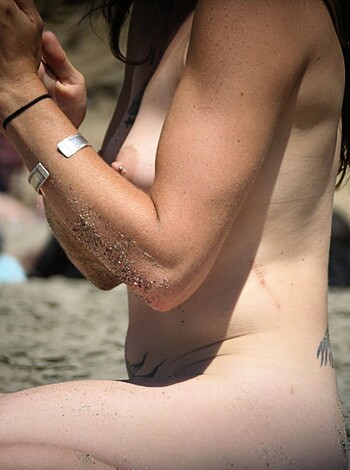 Fucking hot naked chick loungin' on a sandy shore, damn that shit's sexy as fuck.