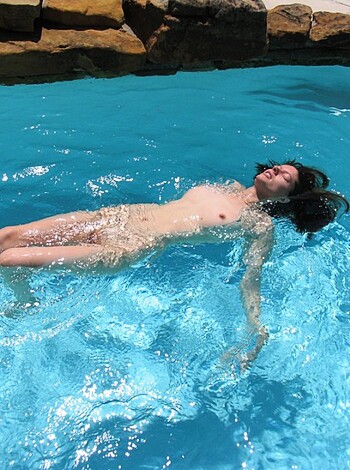 Here's a fucking hot chick with tits dangling from the top, ass up in the water.