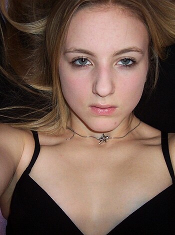 """
This pic shows a sexy babe lying on her back with tits out and her hair swept to one side for your viewing pleasure.
"""