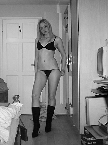 A chick clad in a sexy lingerie with her tits exposed for all to see.