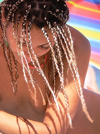 "Check out this fuckin' hot chick in her skimpy bikini, lying on the sandy shore of some goddamn tropical beach."