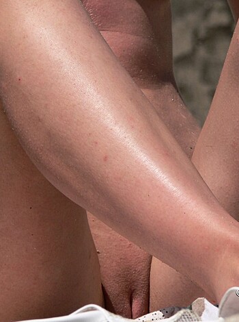 "Two dudes digging their toes into some sand while they screw around."