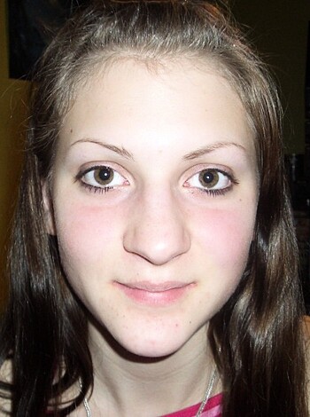 Image of a pink-shirted bitch, her tits are pixelated, she's got black liner on those baby blues, and her fucking hair is straight and brown.