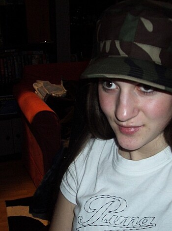 Here's the fucking description of the vulgar image of some fat bitch wearing a goddamn hat and shirt. Fuck her, she looks like shit.