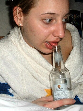 Vulgar description: A busted-ass chick wearing only a towel is sucking down some beers, soaked and sloppy after her shower.