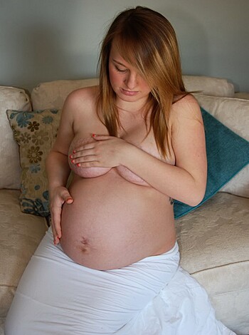 "Check out this naked chick with a bun in the oven, sittin' her fat ass down on a fuckin' couch, showin' off her knocked-up gut."