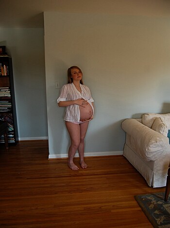 A fucking hot shot of some bitch’s ass naked and posing on her stilettos, with only the tiniest sliver of white shirt covering her nipples in a room somewhere.