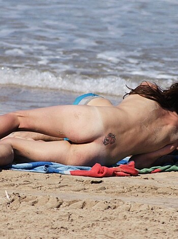 "F*cking hot bitches tanning on the sand, while one's nipples are out and fucking exposed."