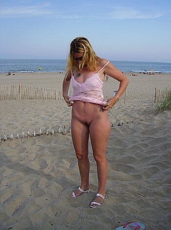 """
Look at this bitch on the beach showing off her titties!
"""