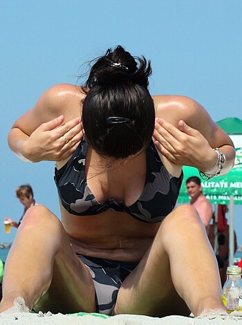 "Here's some fuckin' pic of a fat cunt with a bra and panties sittin' on a sandy dick-shaped beach."