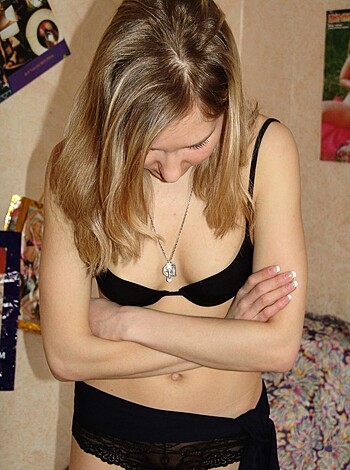 A sexy babe with her tits out rubbing her own body.