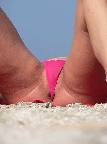 "Busty blonde babe lounging on a fuckin' beach towel, smilin' like a motherfuckin' idiot."