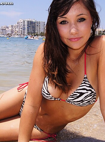 "This fuckin' picture shows a goddamn slutty cunt loungin' around with no bra, in a cheap ass bikini, on some random beach."